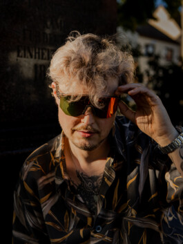 Portrait of a young man wearing sunglasses in golden evening light 
