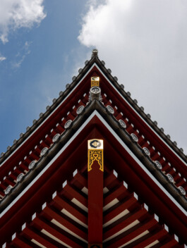 Upward view of red temple roof and sky in Japan 