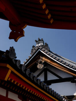 Red wooden temple roof and blue sky in Japan 