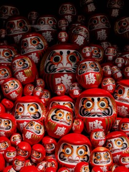 Collection of red Daruma dolls in Japanese temple 